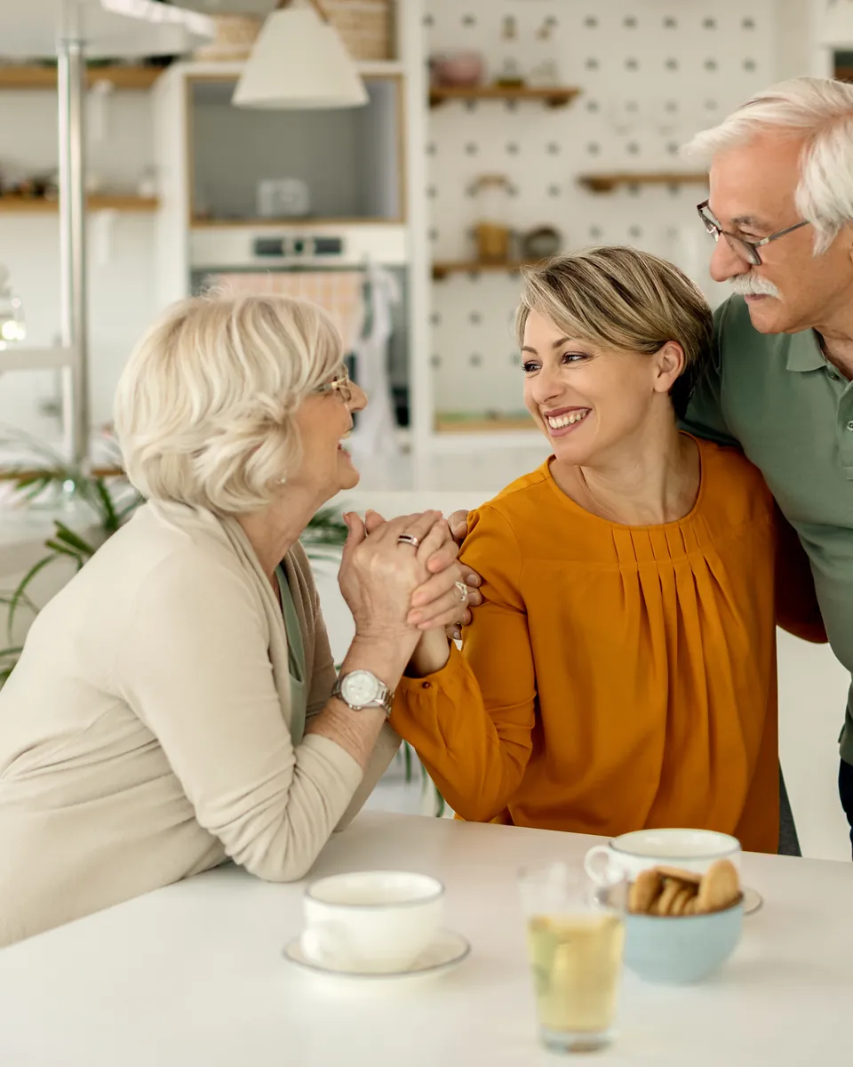 Three generations of a family talking together at the kitchen table